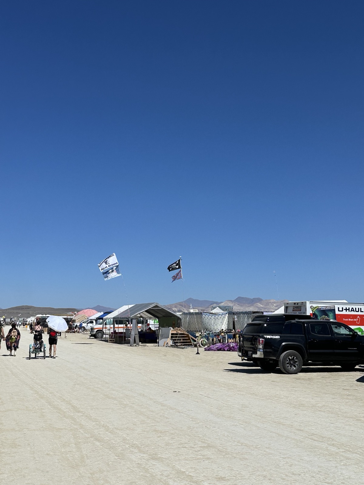 Camp street view — flags, bikes, the neighborhood